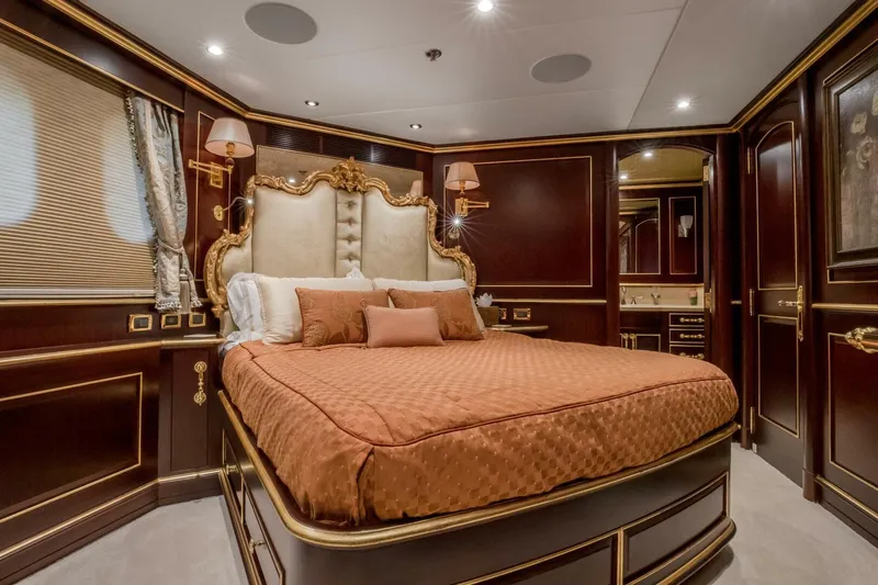 Status Quo Yacht Photos Pics Luxurious bedroom interior on 2009 Horizon Model Tri-Deck yacht with elegant wood paneling.
