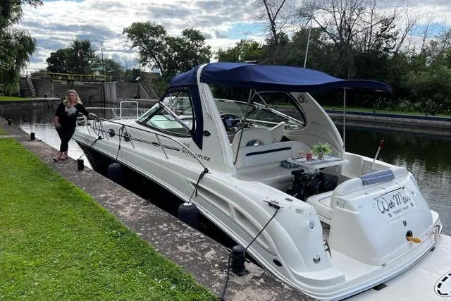 Wet Mess Yacht Photos Pics 2004 Sea Ray 360 Sundancer docked by a canal with a blue canopy.