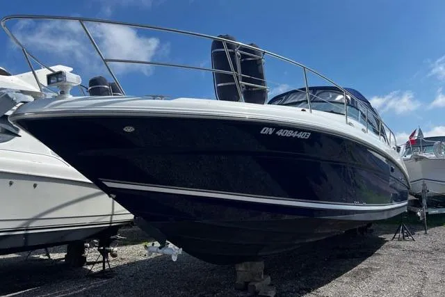 Wet Mess Yacht Photos Pics 2004 Sea Ray 360 Sundancer boat on dry dock under a clear blue sky.