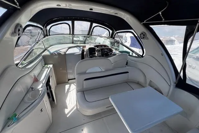 Wet Mess Yacht Photos Pics Interior of 2004 Sea Ray 360 Sundancer yacht with seating and helm, featuring modern design.