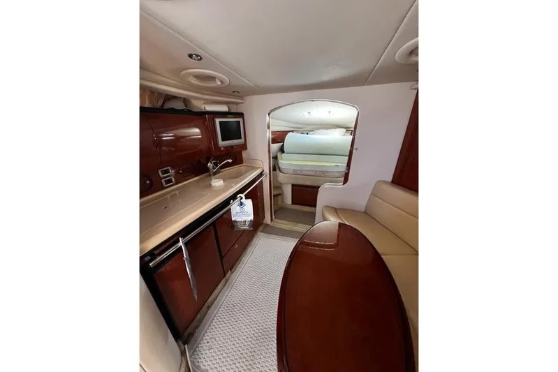 Wet Mess Yacht Photos Pics 2004 Sea Ray 360 Sundancer interior with kitchenette, seating, and sleeping area.