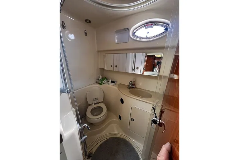 Wet Mess Yacht Photos Pics 2004 Sea Ray 360 Sundancer bathroom with toilet, sink, and storage cabinets.