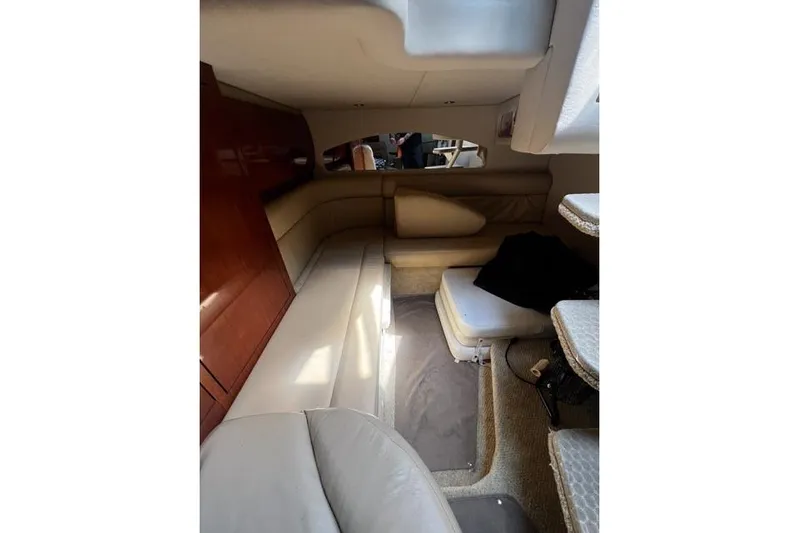 Wet Mess Yacht Photos Pics Interior cabin of 2004 Sea Ray 360 Sundancer with beige seating and wooden accents.