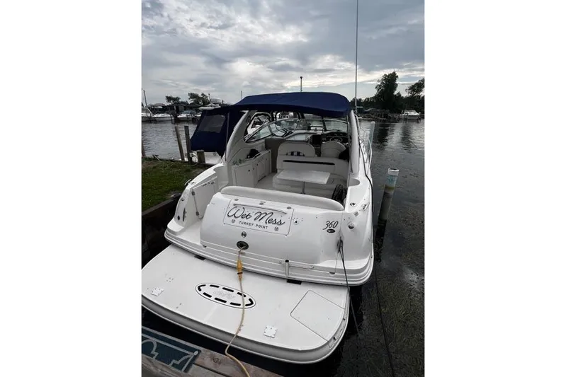 Wet Mess Yacht Photos Pics 2004 Sea Ray 360 Sundancer docked, featuring a spacious deck and blue canopy.