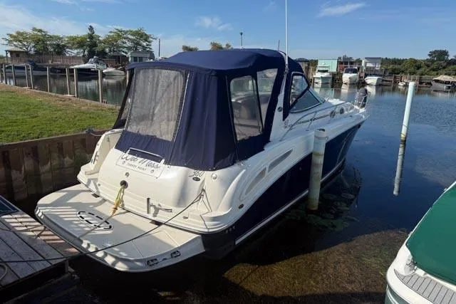 Wet Mess Yacht Photos Pics 2004 Sea Ray 360 Sundancer docked at a marina, featuring a blue canopy.