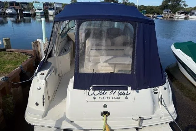 Wet Mess Yacht Photos Pics 2004 Sea Ray 360 Sundancer docked, featuring blue canvas cover and "Wet Mess" nameplate.