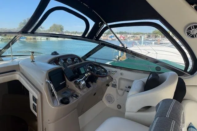 Wet Mess Yacht Photos Pics 2004 Sea Ray 360 Sundancer helm with modern controls and waterfront view.