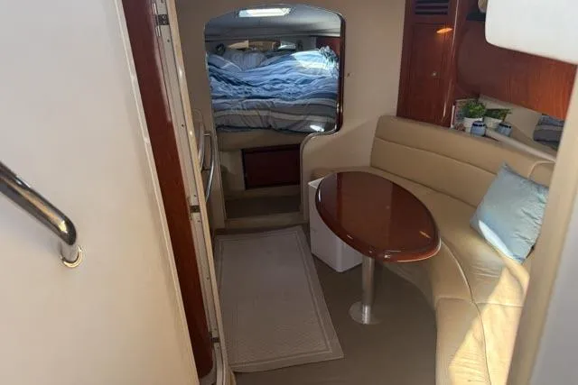 Wet Mess Yacht Photos Pics Interior of 2004 Sea Ray 360 Sundancer with cozy seating and cabin bed.