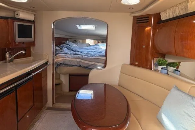 Wet Mess Yacht Photos Pics Interior of 2004 Sea Ray 360 Sundancer yacht with cozy seating and elegant wood finishes.