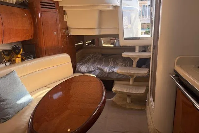 Wet Mess Yacht Photos Pics Interior of 2004 Sea Ray 360 Sundancer yacht with cozy seating and sleeping area.