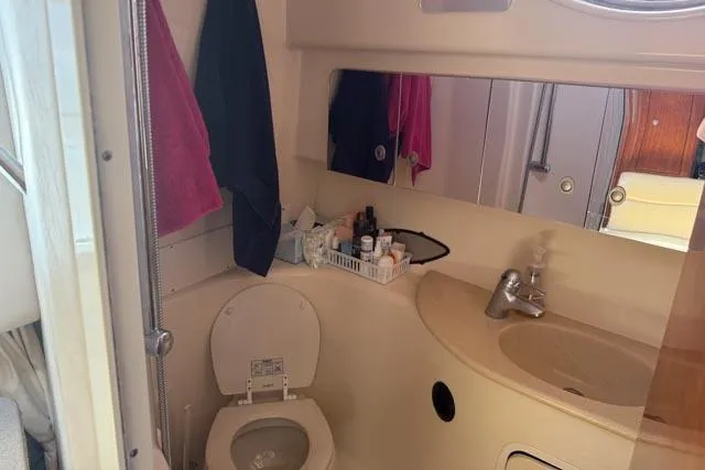 Wet Mess Yacht Photos Pics 2004 Sea Ray 360 Sundancer bathroom with toilet, sink, and toiletries.