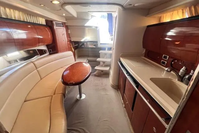 Wet Mess Yacht Photos Pics Interior of 2004 Sea Ray 360 Sundancer yacht with elegant seating and kitchenette.