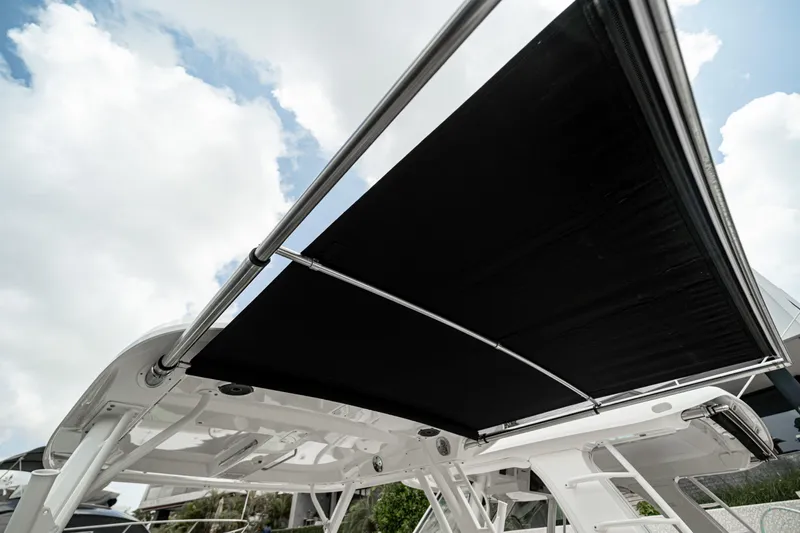 2019 Boston Whaler 350 Realm @ Cancun Yacht Photos Pics 2019 Boston Whaler 350 Realm boat canopy against a cloudy sky.