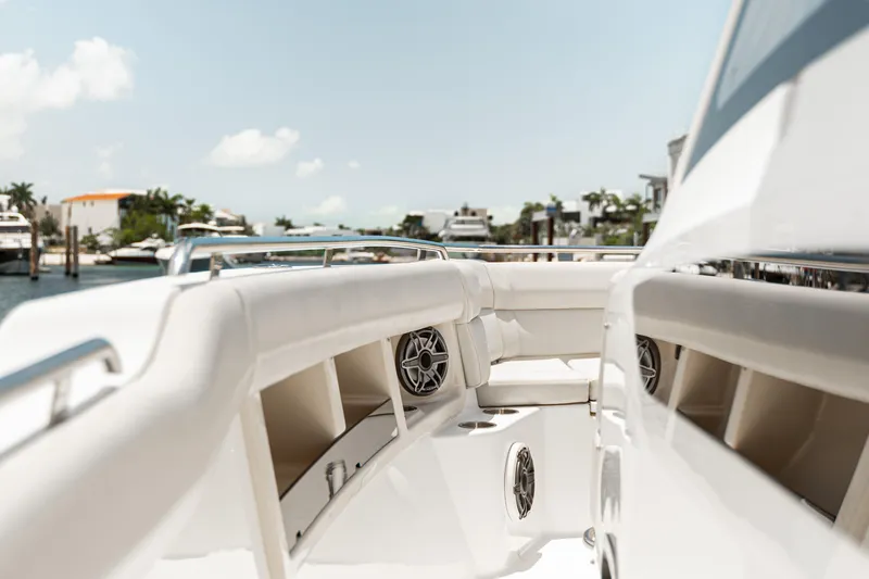 2019 Boston Whaler 350 Realm @ Cancun Yacht Photos Pics 2019 Boston Whaler 350 Realm boat interior with seating and speakers, docked near waterfront homes.