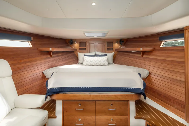 Dayglow Yacht Photos Pics Luxurious cabin interior of 2020 MJM 53z yacht with wooden paneling and cozy bedding.