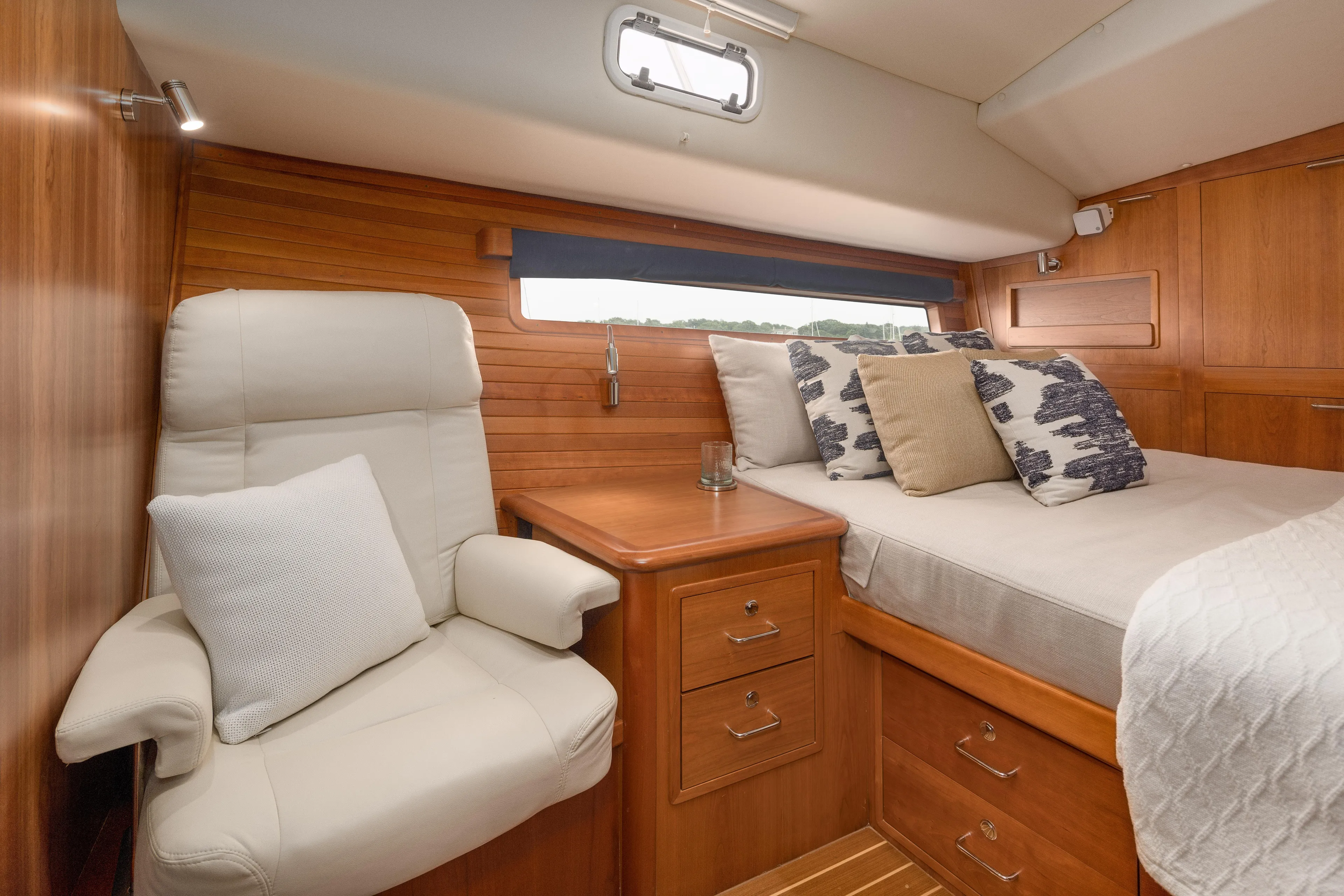 Dayglow Yacht Photos Pics Luxurious cabin interior of 2020 MJM 53z yacht with bed and seating area.