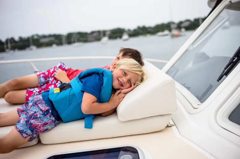 Dayglow Yacht Photos Pics Children relaxing on a 2020 MJM 53z boat, enjoying a sunny day on the water.