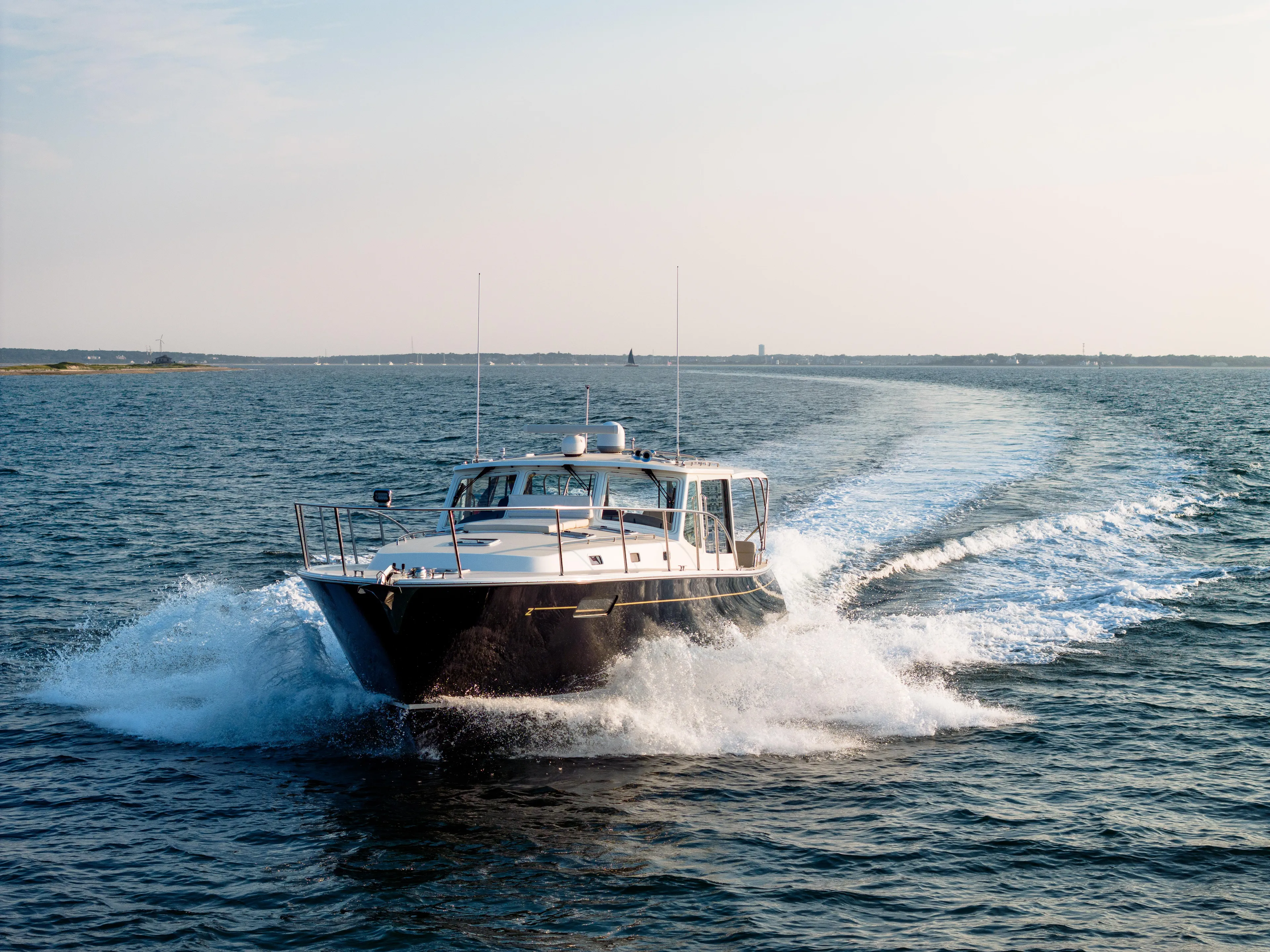 Dayglow Yacht Photos Pics MJM 53z 2020 yacht cruising on open water, creating a dynamic wake.