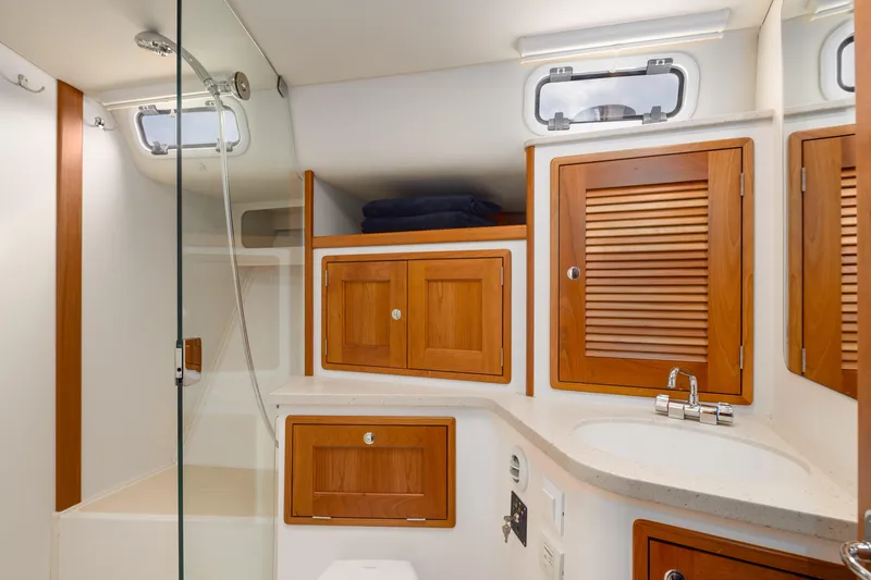 Dayglow Yacht Photos Pics Luxurious bathroom in 2020 MJM 53z yacht with wooden cabinets and modern fixtures.