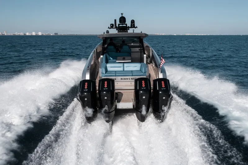 Robin's Nest Yacht Photos Pics 2023 Vanquish Yachts VQ45 Veloce Hardtop cruising on open water, rear view.