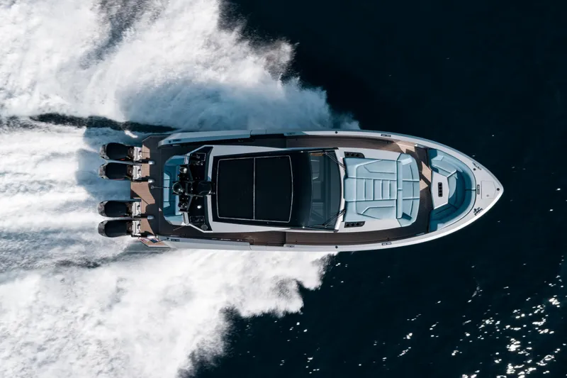 Robin's Nest Yacht Photos Pics 2023 Vanquish Yachts VQ45 Veloce Hardtop cruising on open water, aerial view.