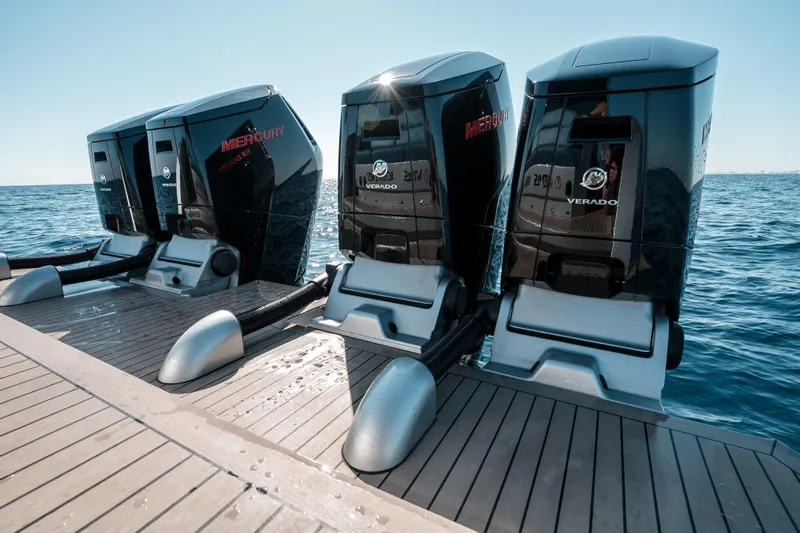 Robin's Nest Yacht Photos Pics Powerful Mercury Verado engines on 2023 Vanquish Yachts VQ45 Veloce Hardtop, docked by the sea.