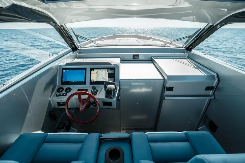 Robin's Nest Yacht Photos Pics 2023 Vanquish Yachts VQ45 Veloce Hardtop cockpit with modern controls and ocean view.