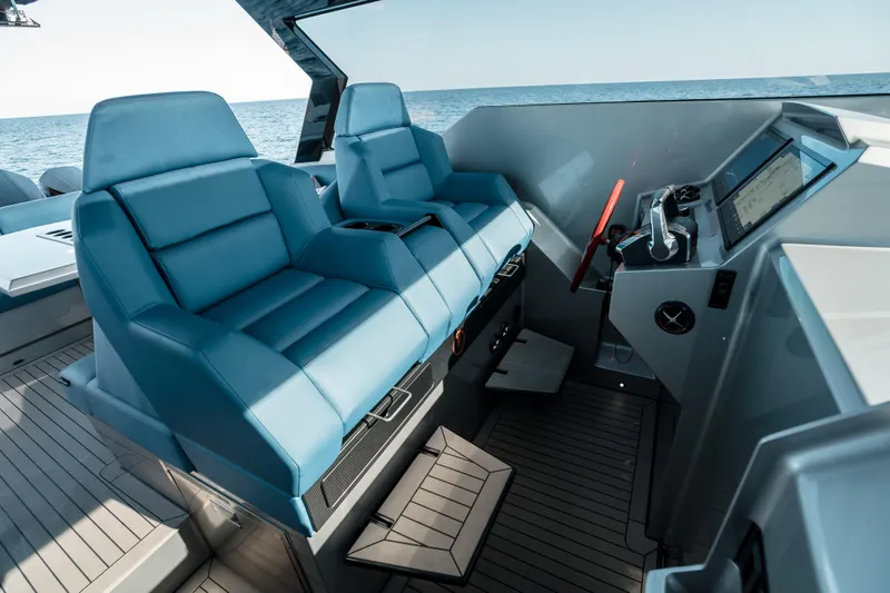 Robin's Nest Yacht Photos Pics 2023 Vanquish Yachts VQ45 Veloce Hardtop cockpit with blue seats and modern controls.