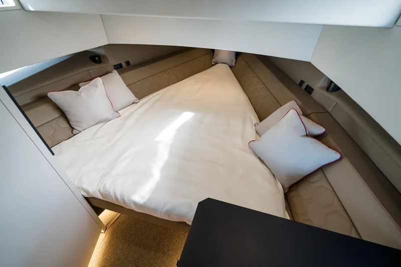 Robin's Nest Yacht Photos Pics Luxurious cabin interior of 2023 Vanquish Yachts VQ45 Veloce Hardtop with cozy bedding.