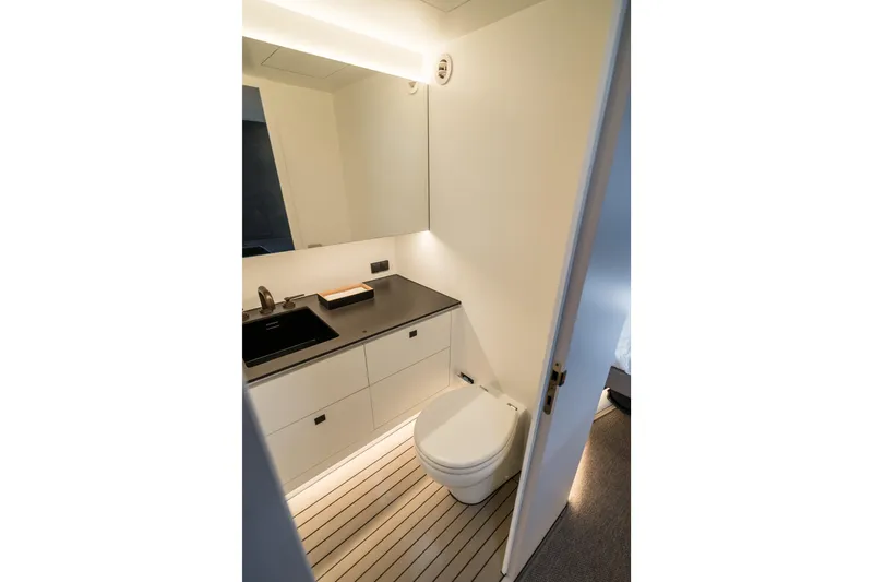 Robin's Nest Yacht Photos Pics Modern bathroom interior of 2023 Vanquish Yachts VQ45 Veloce Hardtop, featuring sleek design elements.