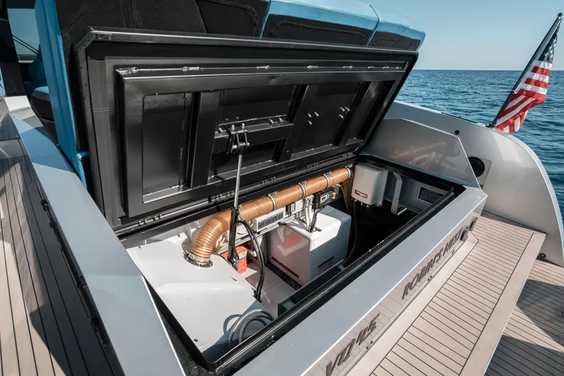 Robin's Nest Yacht Photos Pics 2023 Vanquish Yachts VQ45 Veloce Hardtop engine compartment with American flag, open at sea.