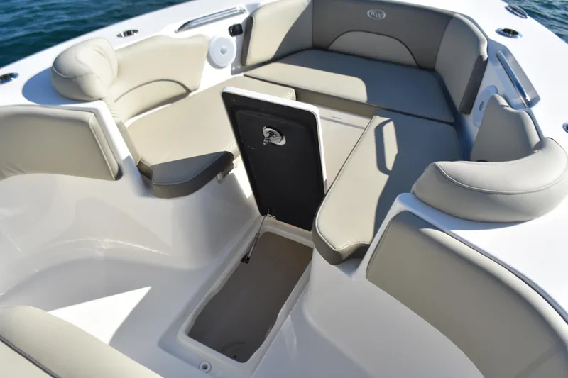  Yacht Photos Pics 2024 Key West 263 FS boat interior with cushioned seating and storage compartment.