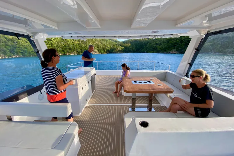  Yacht Photos Pics People relaxing on a 2022 Leopard 46 Powercat yacht, enjoying scenic ocean views.