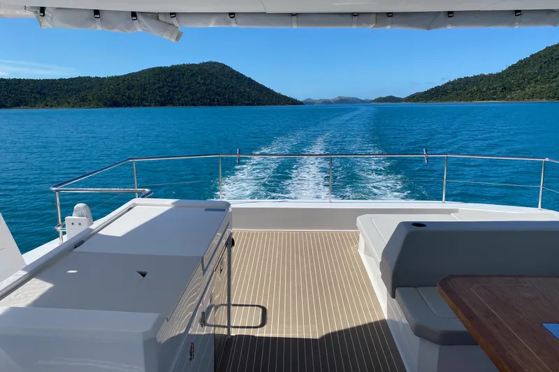  Yacht Photos Pics Leopard 46 Powercat 2022 cruising on blue waters with scenic island views.