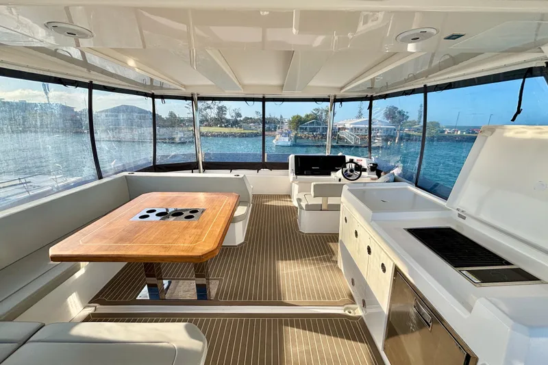  Yacht Photos Pics Luxurious interior of 2022 Leopard 46 Powercat yacht with dining area and helm station.