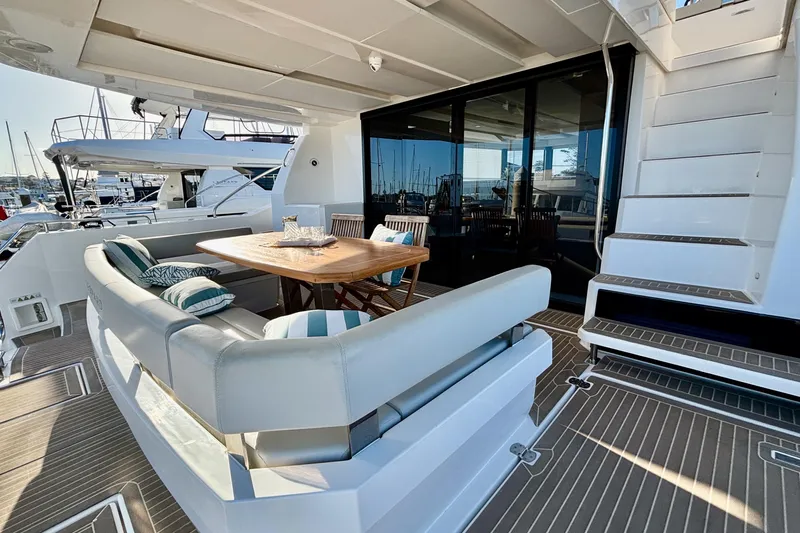  Yacht Photos Pics Luxurious 2022 Leopard 46 Powercat yacht with elegant outdoor seating and dining area.