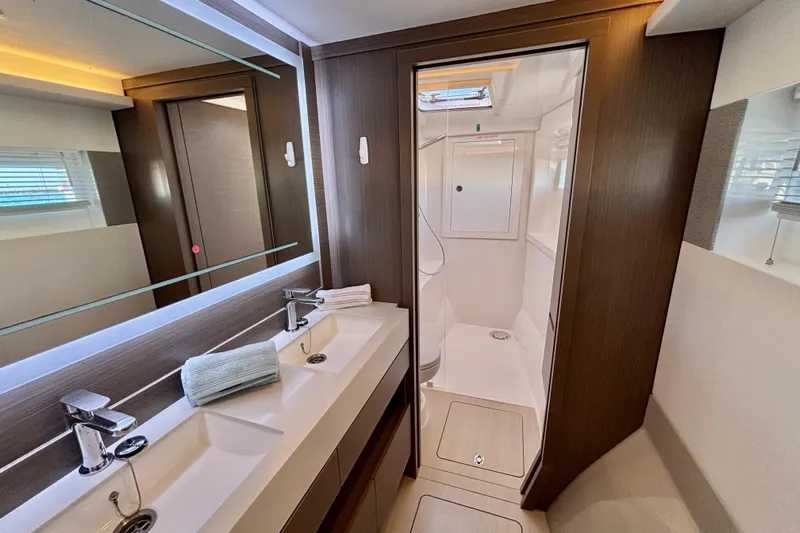  Yacht Photos Pics Luxurious bathroom on 2022 Leopard 46 Powercat yacht with dual sinks and modern shower.