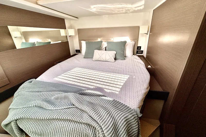  Yacht Photos Pics Luxurious bedroom interior of 2022 Leopard 46 Powercat yacht with cozy bedding.