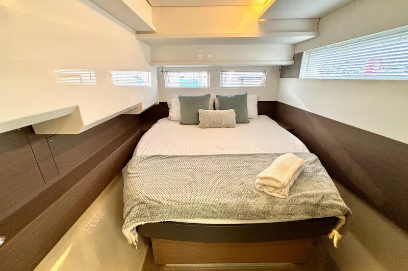  Yacht Photos Pics Luxurious bedroom interior of 2022 Leopard 46 Powercat yacht with cozy bedding.