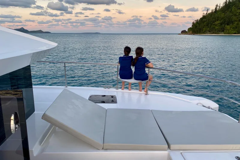  Yacht Photos Pics Two children on a 2022 Leopard 46 Powercat, enjoying a serene ocean view.