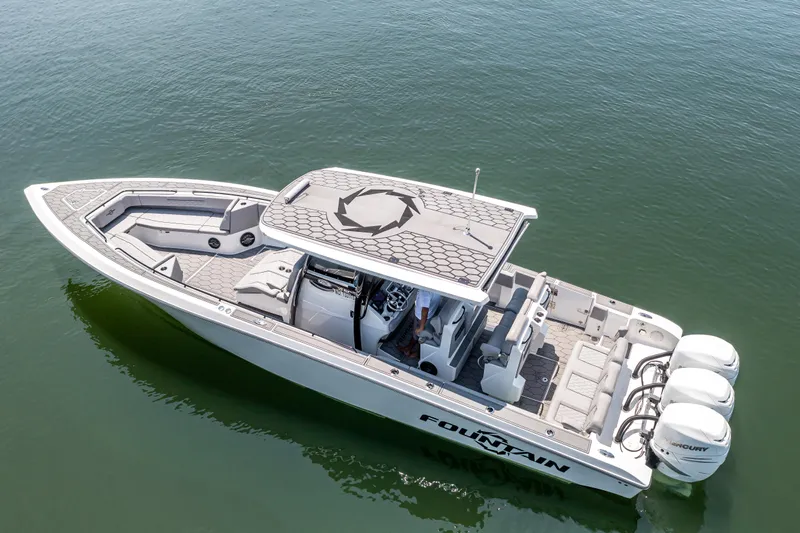  Yacht Photos Pics 2023 Fountain 38 SC boat on calm water, featuring sleek design and triple outboard engines.