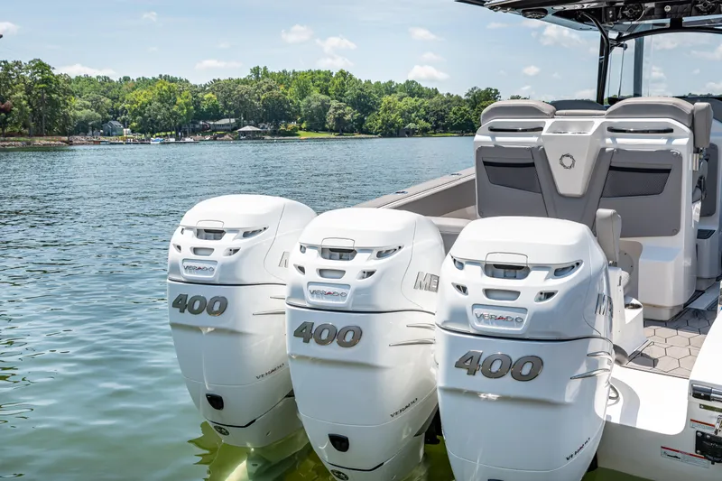  Yacht Photos Pics 2023 Fountain 38 SC boat with triple 400 horsepower engines on a serene lake.
