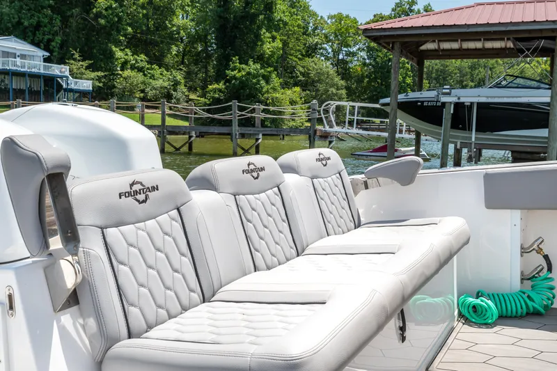  Yacht Photos Pics 2023 Fountain 38 SC boat with luxurious seating at a dockside location.