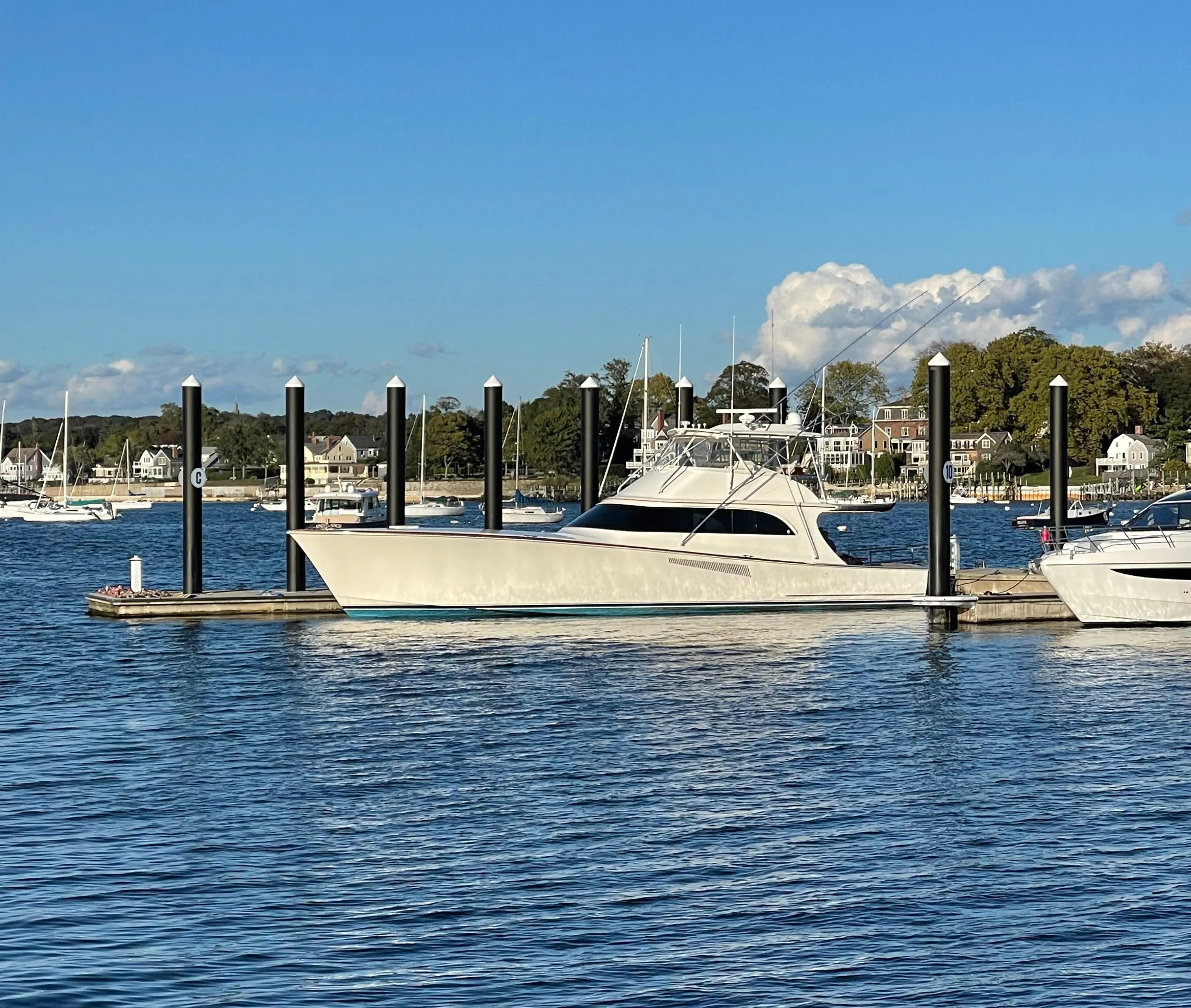 1999 Hines-Farley SPORTFISHERMAN yacht docked in a serene marina setting.