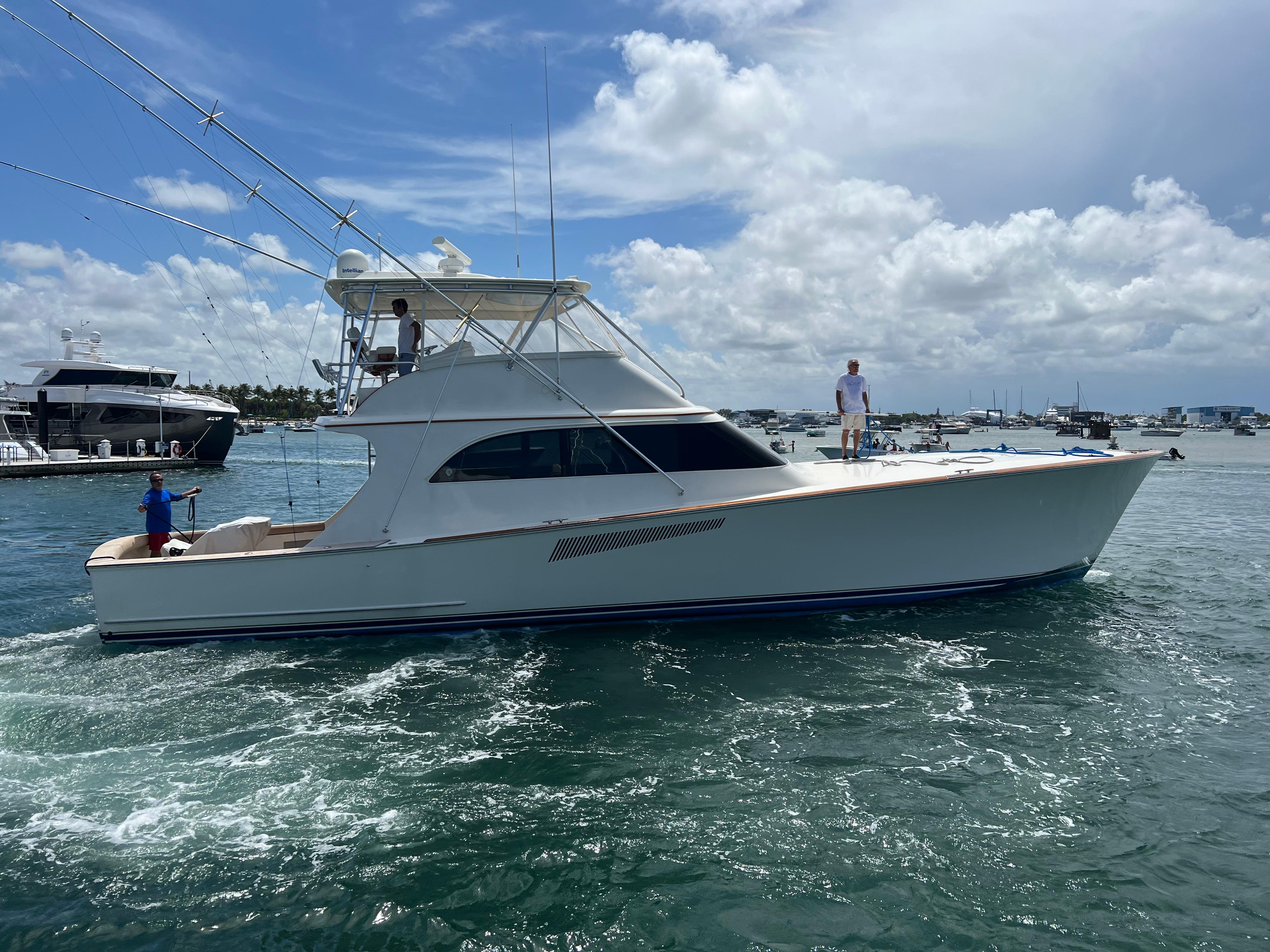 1999 Hines-Farley SPORTFISHERMAN yacht cruising on a sunny day with people on board.