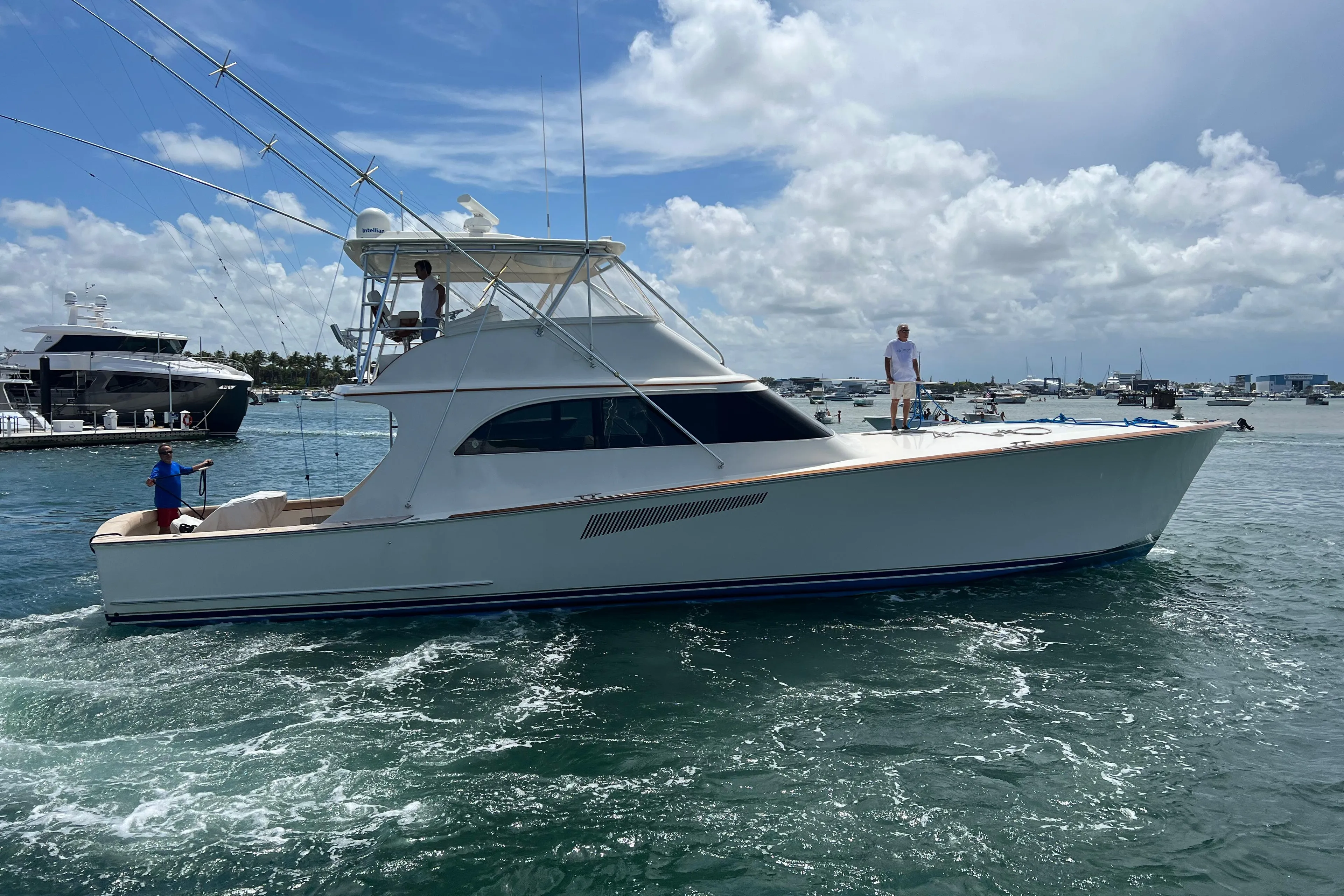 1999 Hines-Farley SPORTFISHERMAN yacht cruising on a sunny day with people on board.