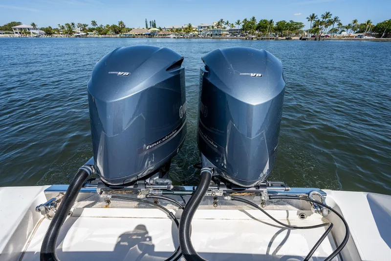  Yacht Photos Pics Twin Yamaha V8 outboard engines on a 2013 Jupiter 34 boat, with scenic waterfront view.