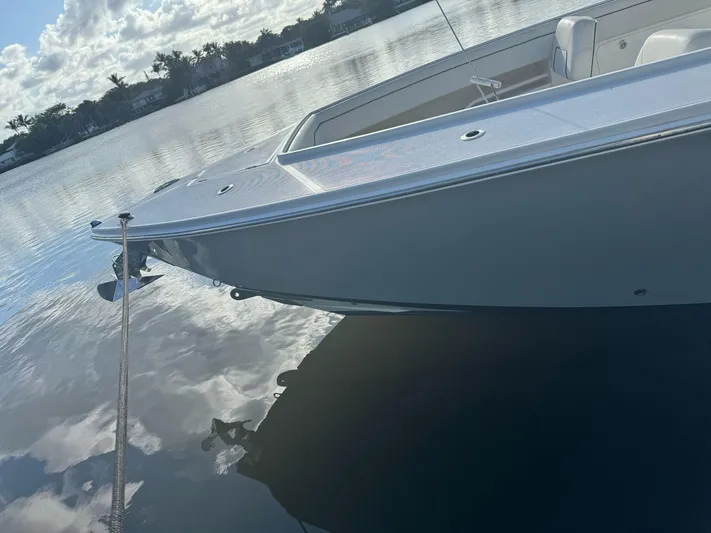  Yacht Photos Pics 2013 Jupiter 34 boat docked on calm water under a cloudy sky.