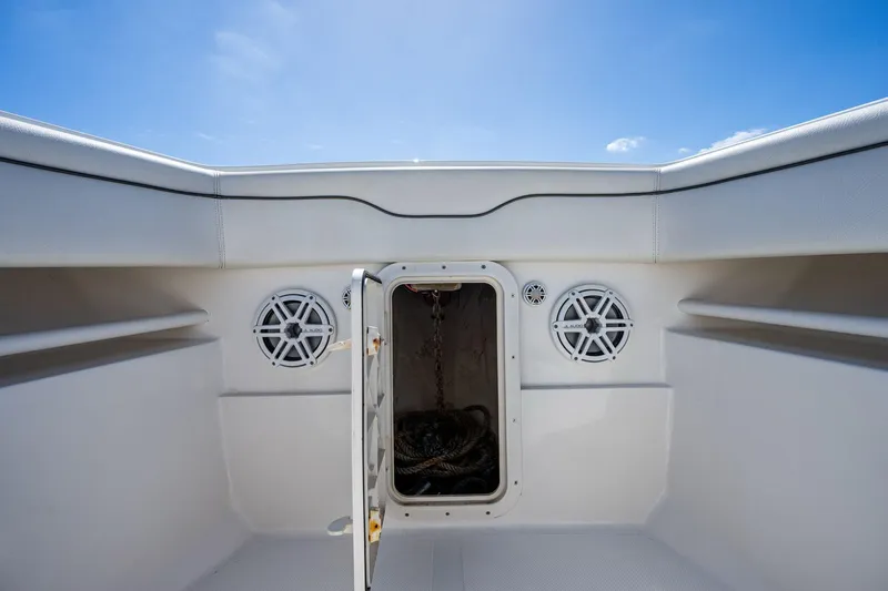  Yacht Photos Pics 2013 Jupiter 34 boat interior with open storage compartment and speakers under clear blue sky.