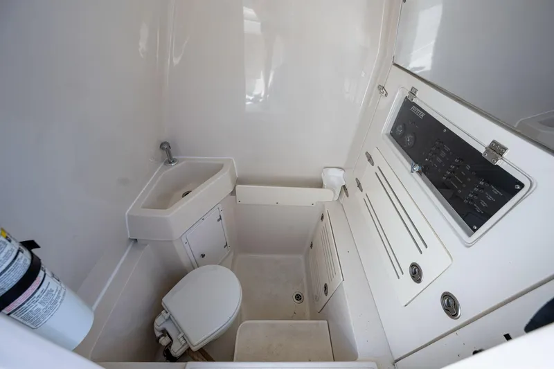  Yacht Photos Pics Compact bathroom in 2013 Jupiter 34 boat with sink, toilet, and control panel.